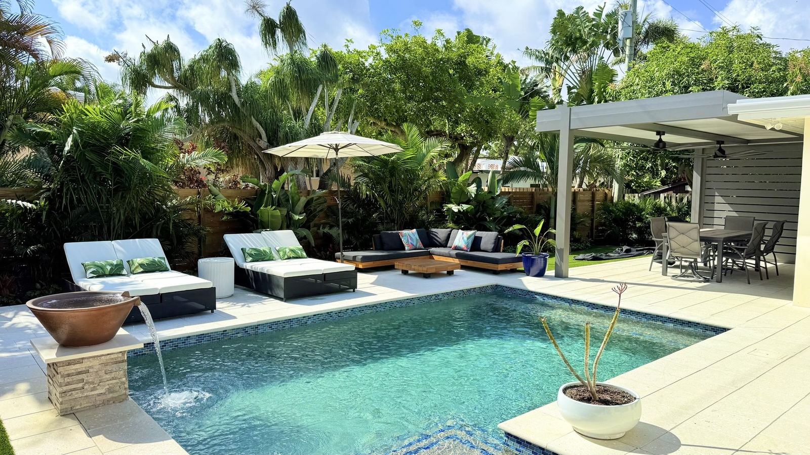 Screen-enclosed lanai with pool and pavers by Cliff's