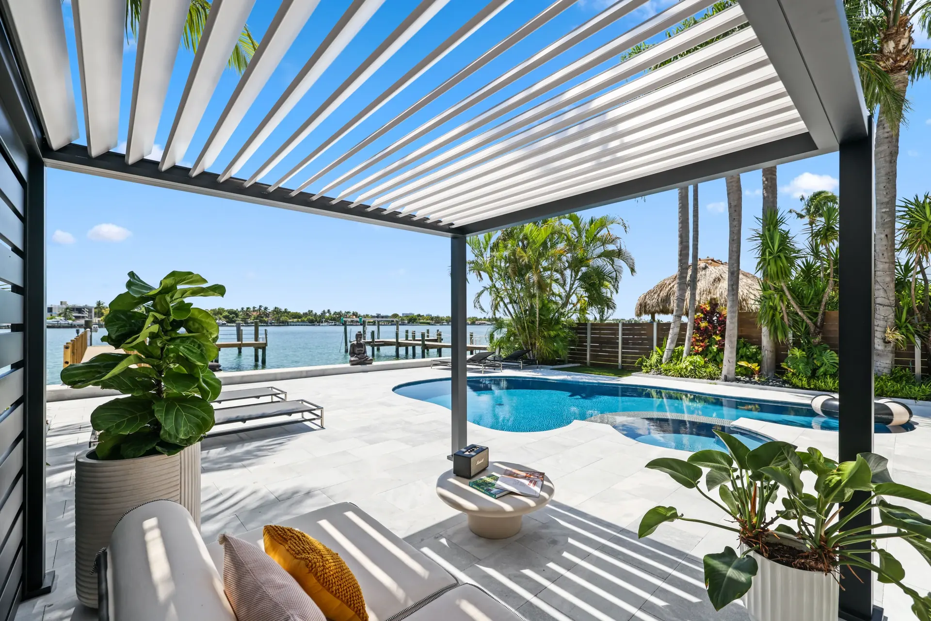 A Cliff's poolside lounge with louvered K-bana shade structure overlooking the pool and waterway