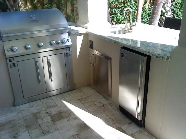 Cliff's Pools & Patios sleek stainless outdoor kitchen with black granite - serving Greenacres, FL