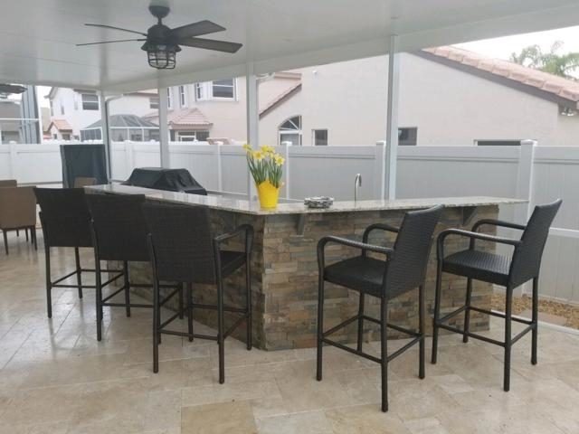 Cliff's Pools & Patios modern outdoor kitchen overlooking the pool - serving Lighthouse Point, FL